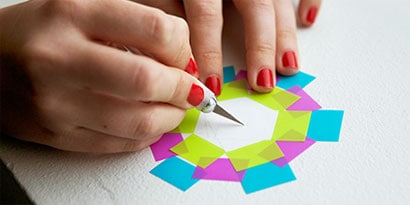 Grab a parent to help you cut a small slit in the center of the flower, and insert the end of a pipe cleaner.